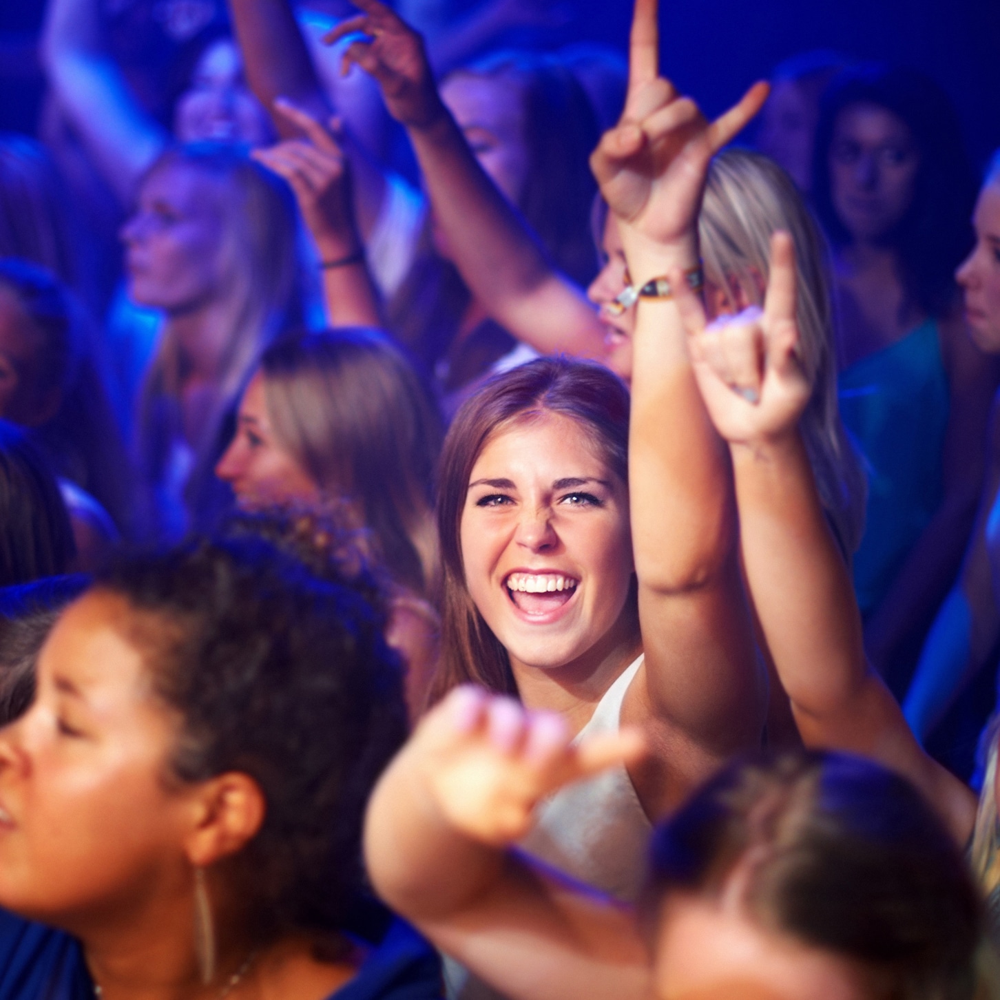 Illustrative of people in a crowd enjoying a music concert
