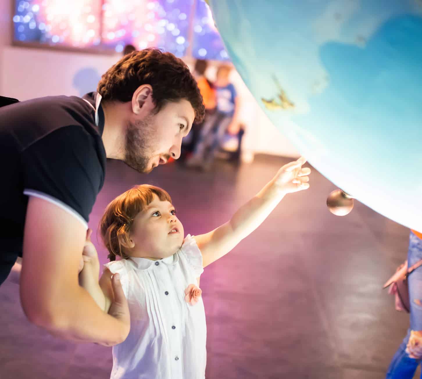 Father and child looking at attraction