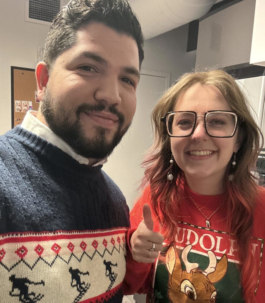 two people from Leap's customer care team wearing Christmas sweaters