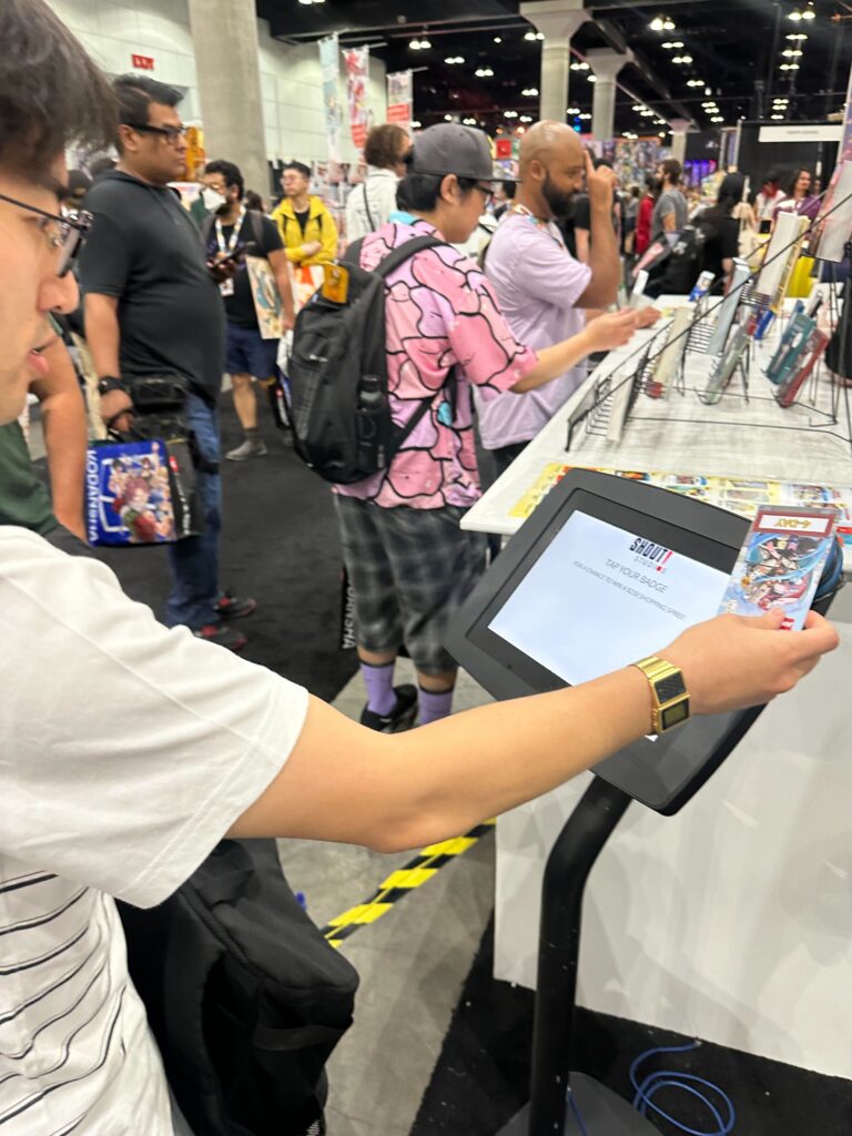 an attendee scanning their badge at a kiosk at an event powered by Leap Event Technology